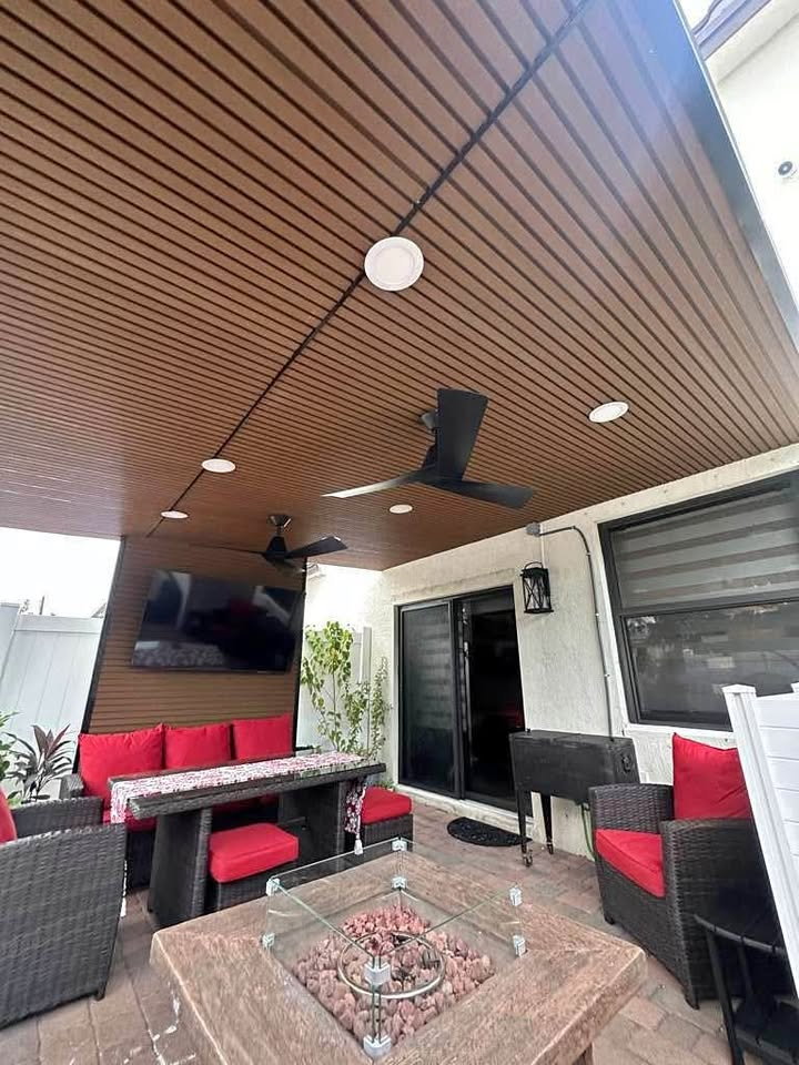 Covered patio lounge with wood ceiling, TV and seating