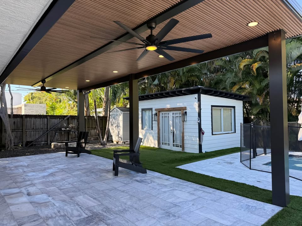 Poolside patio cover with wood ceiling and lounge chairs