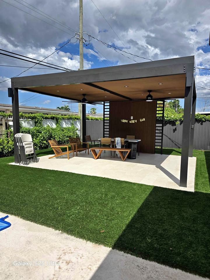 Freestanding pergola with dining set on artificial turf